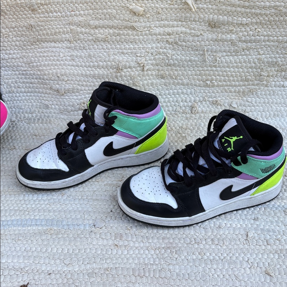 Nike Air Jordan’s Black and White Sneakers with Green and Purple Accents.
